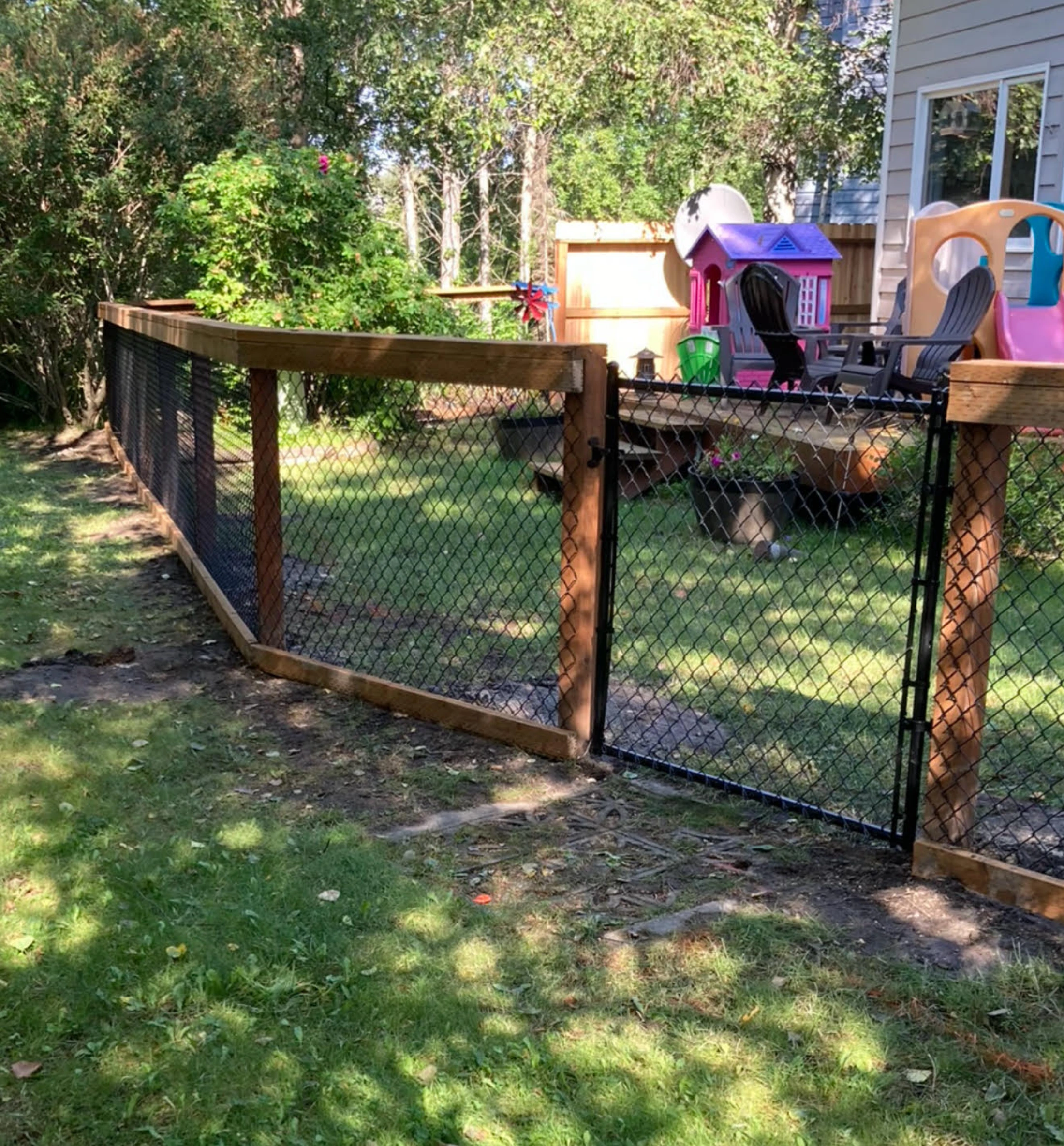 California-style chain link fence with cedar frame in residential Anchorage backyard