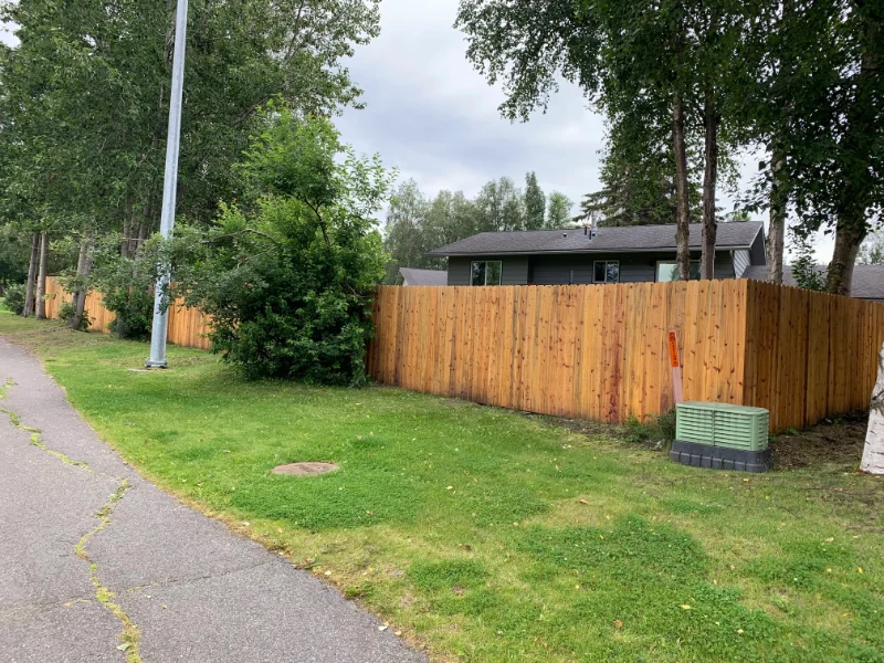 Family-friendly backyard fence with secure gate in Alaska